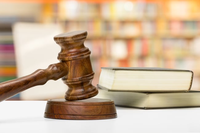wooden-gavel-and-books-on-wooden-table